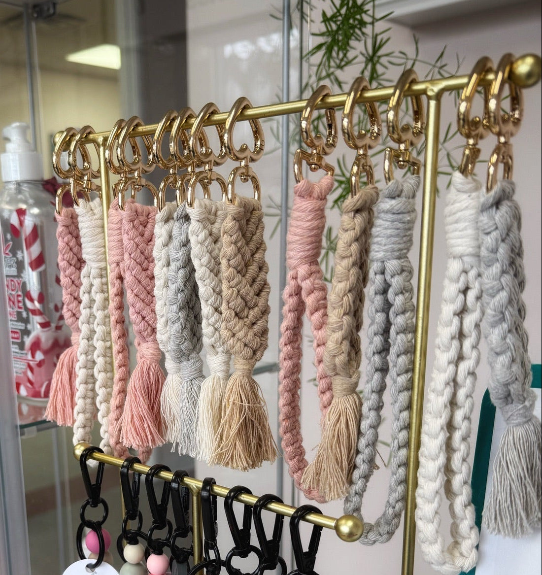 Gold keychain holder with various colorful keychains displayed in a store setting.