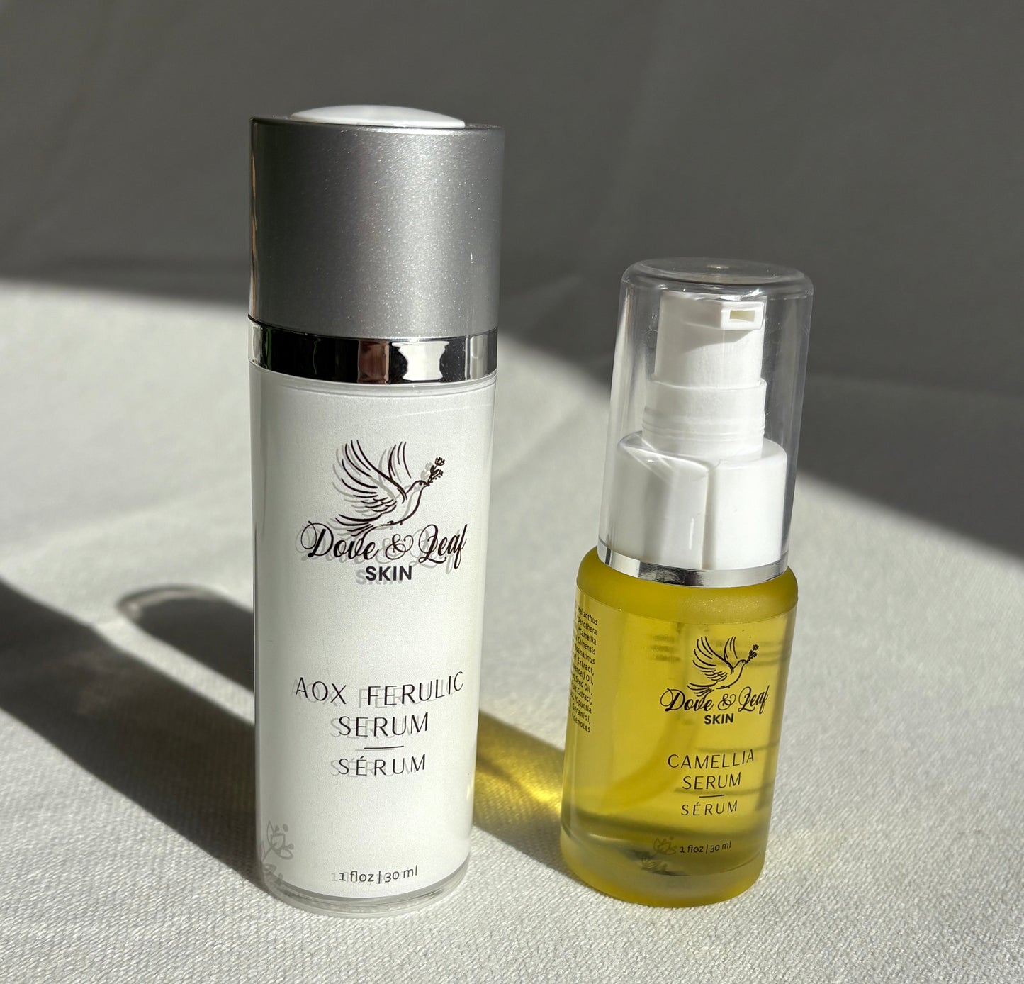Two skincare products on a textured surface