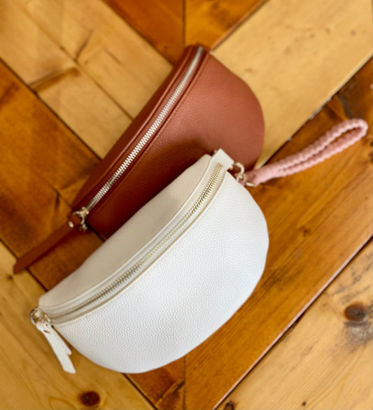 Brown and white round pouches on a wooden surface