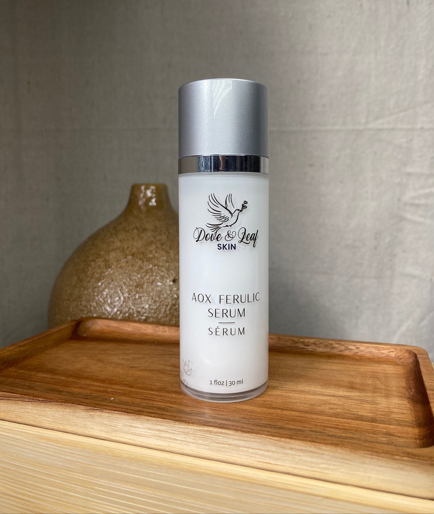 Skincare serum bottle on a wooden surface with a neutral background